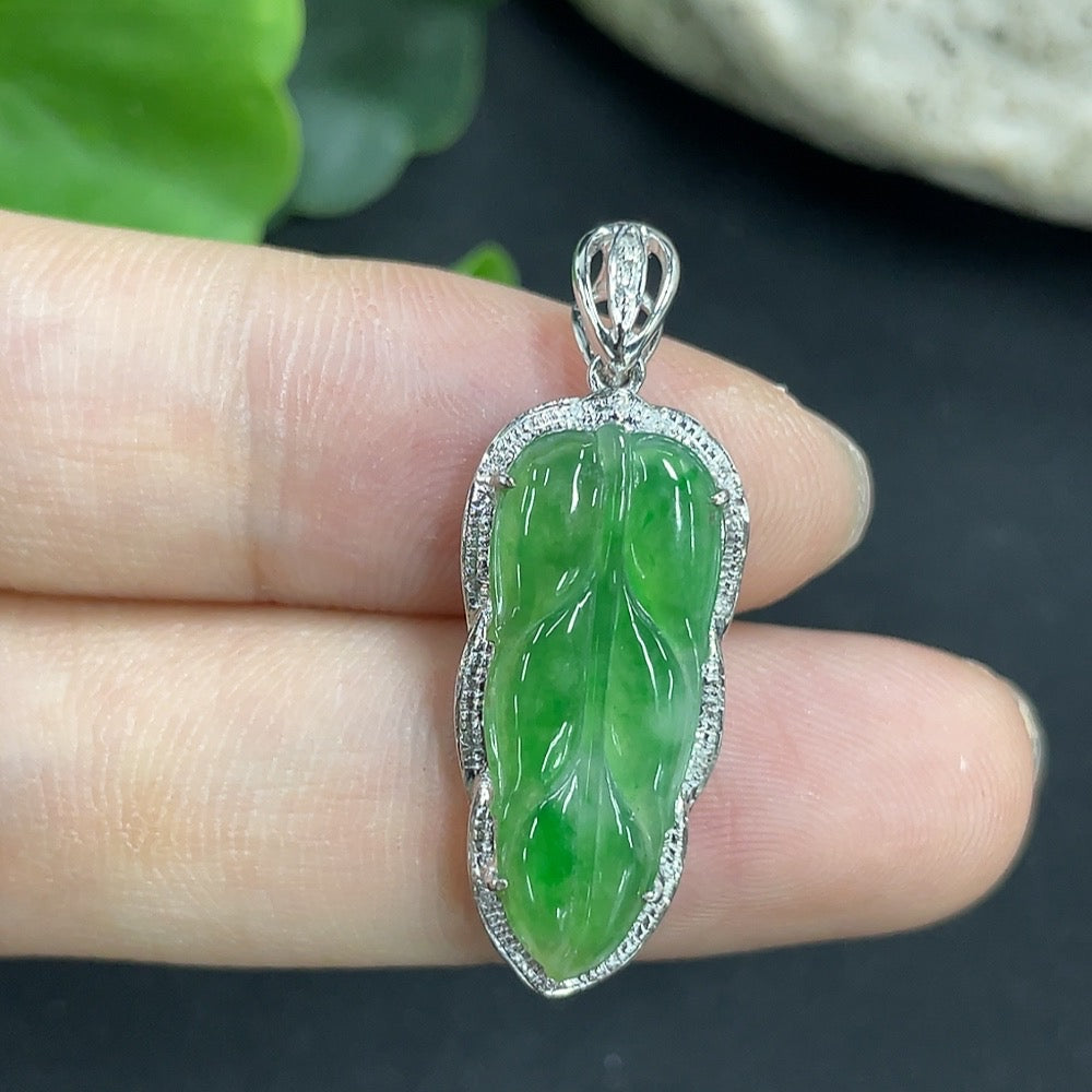 Jadeite leaf pendant in 18K gold with diamond accents, elegant necklace featuring detailed leaf design and sparkling gemstones.