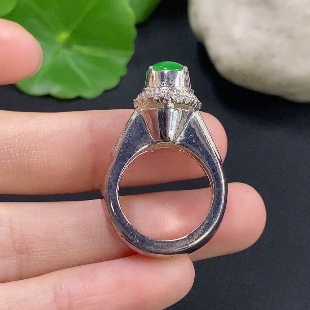 Jadeite cabochon jewelry with non-gold setting, featuring a smooth, polished green gemstone in a sleek, modern display.