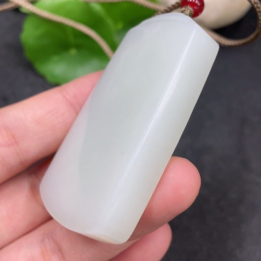 Huiliu certified Hetian jade pendant with a plain, smooth design showcasing elegant green jade craftsmanship.