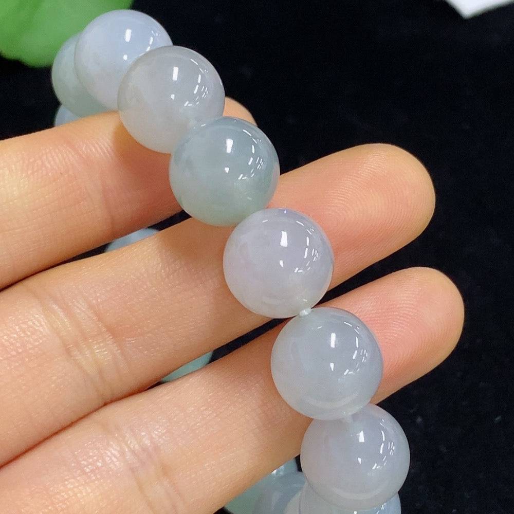 Huiliu certified jadeite bracelet with 12.2mm smooth jade beads, showcasing polished green jade stone on a white background.