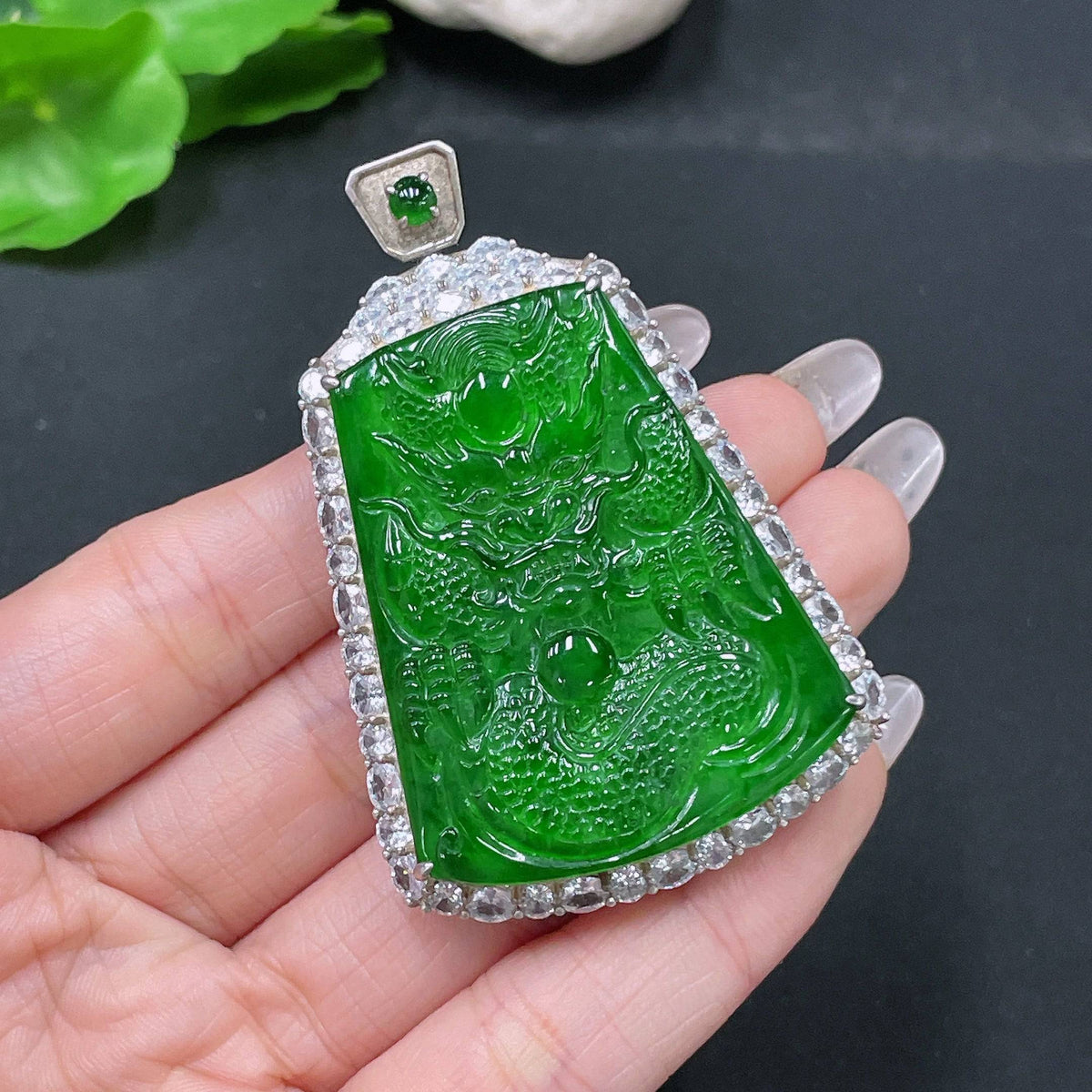 Jadeite pendant featuring a dragon plaque, crafted from green jade with detailed carvings, weighing approximately 26.55g.