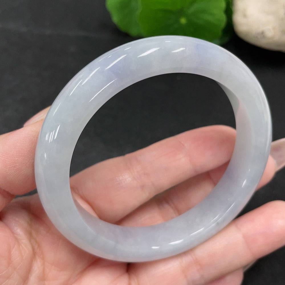 Jadeite round bangle in green jade, size 55.7, weighing approximately 57.52g, with smooth polished surface and natural jade color.