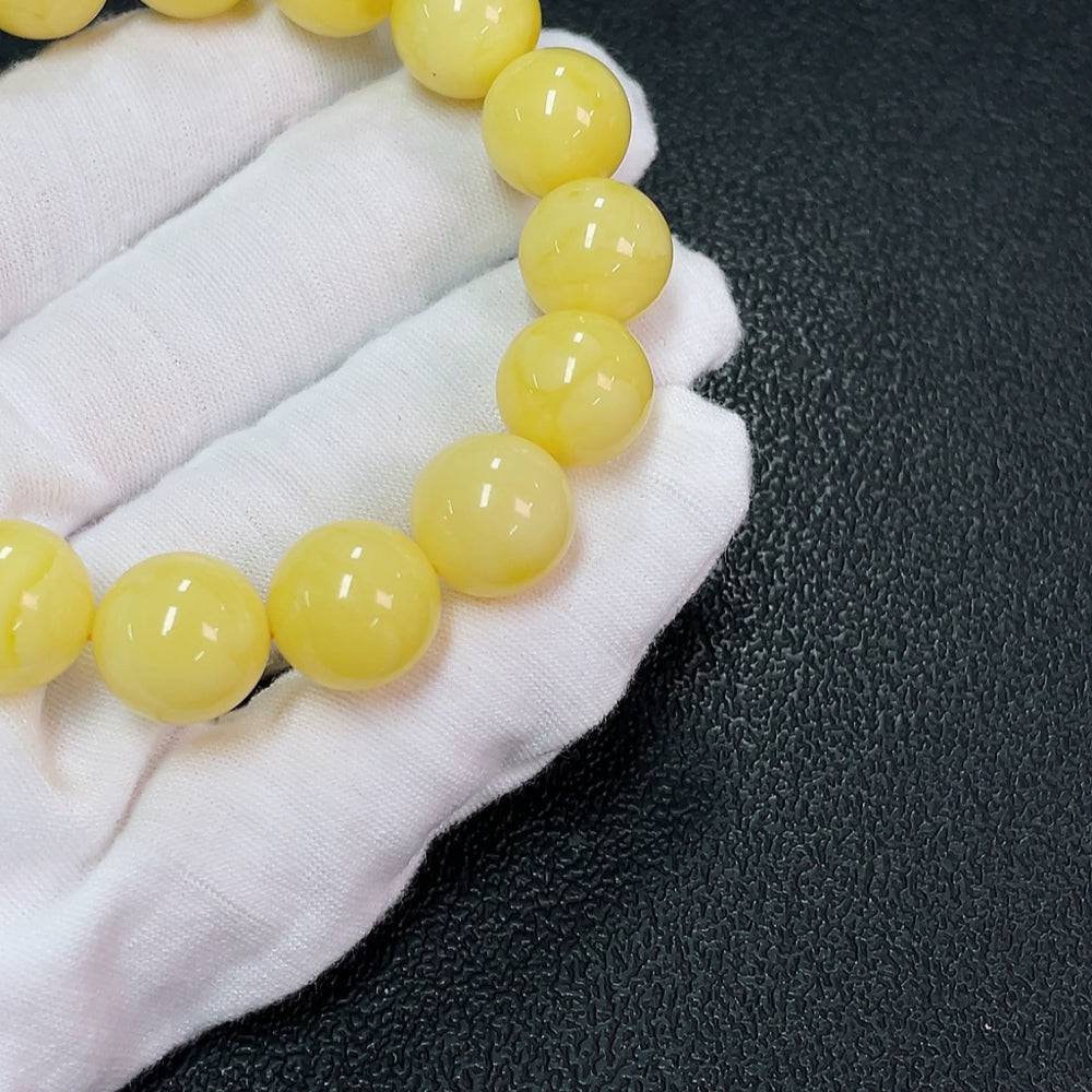 Huiliu Amber Beeswax bracelet with 13mm beads, natural amber color and handcrafted design, certified by Huiliu HQ.