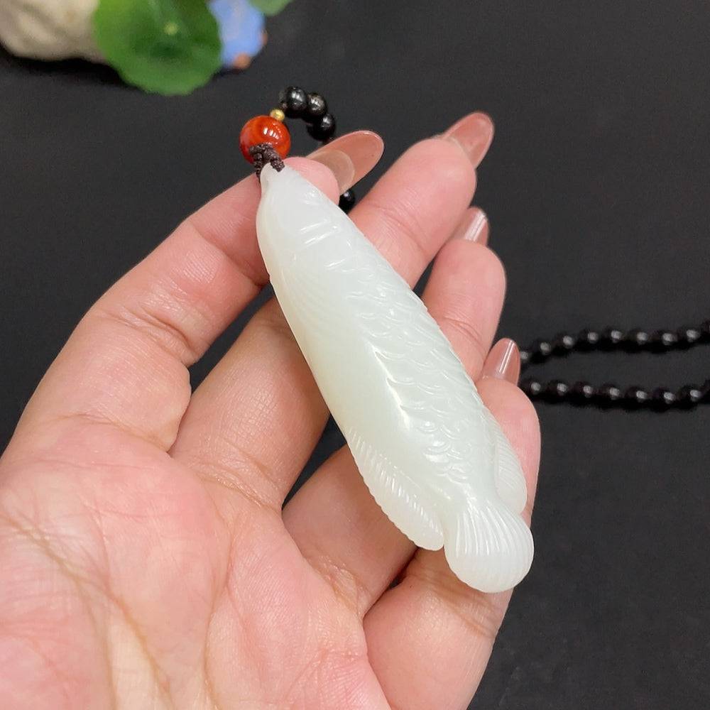 Huiliu HQ Hetian jade pendant with natural green jade stone, beautifully polished, traditional jewelry piece on a plain background.