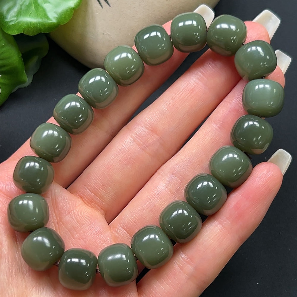 Hetian jade bracelet with 12mm beads from HKHQ, featuring smooth, polished green jade stones on a delicate bracelet.
