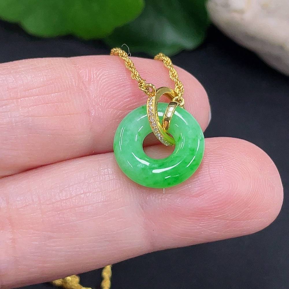 Jadeite inlaid necklace with 18K gold setting, featuring a polished green jade pendant on a delicate gold chain.