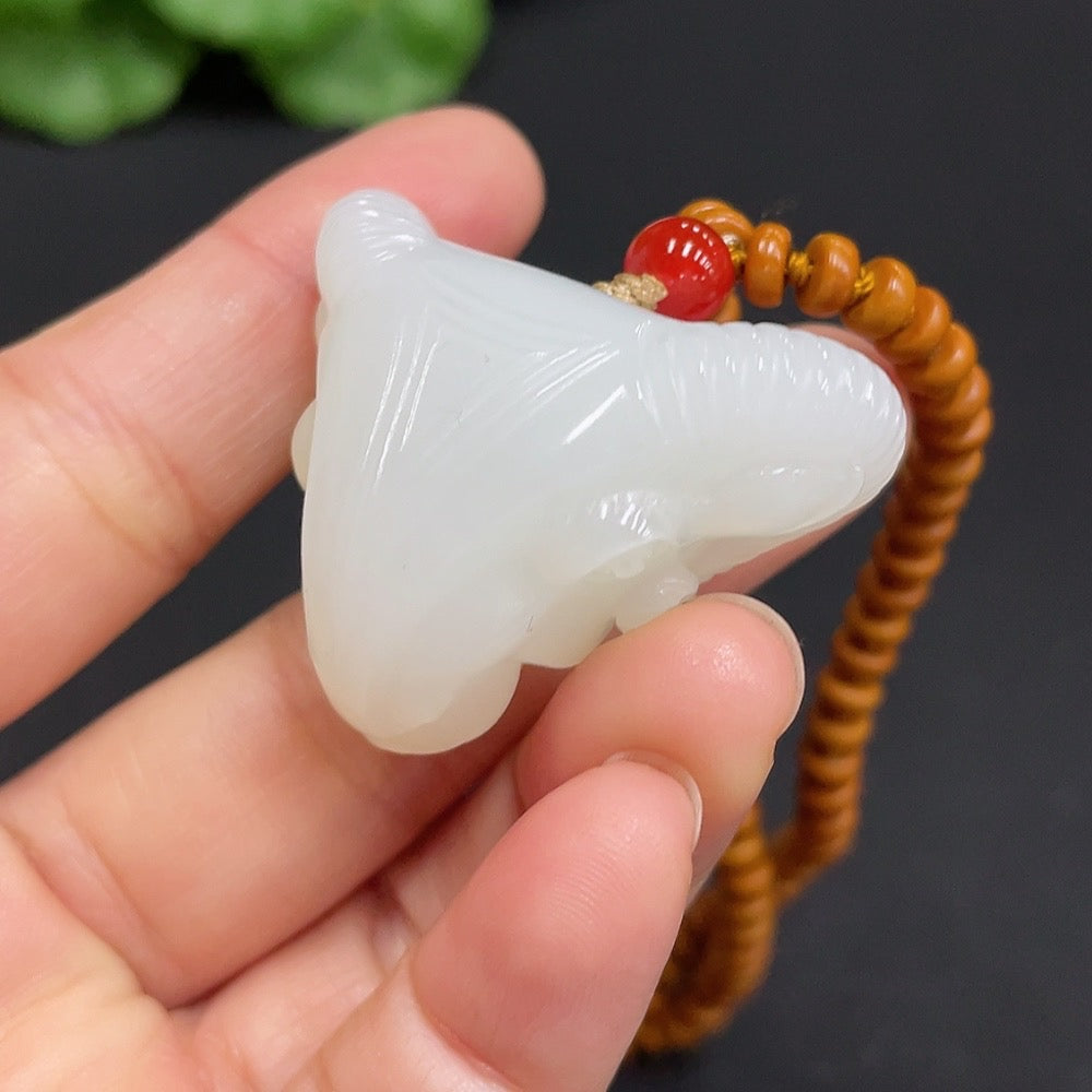Huiliu HQ Hetian Jade pendant featuring an auspicious ram design, crafted from high-quality green jade with intricate carvings.