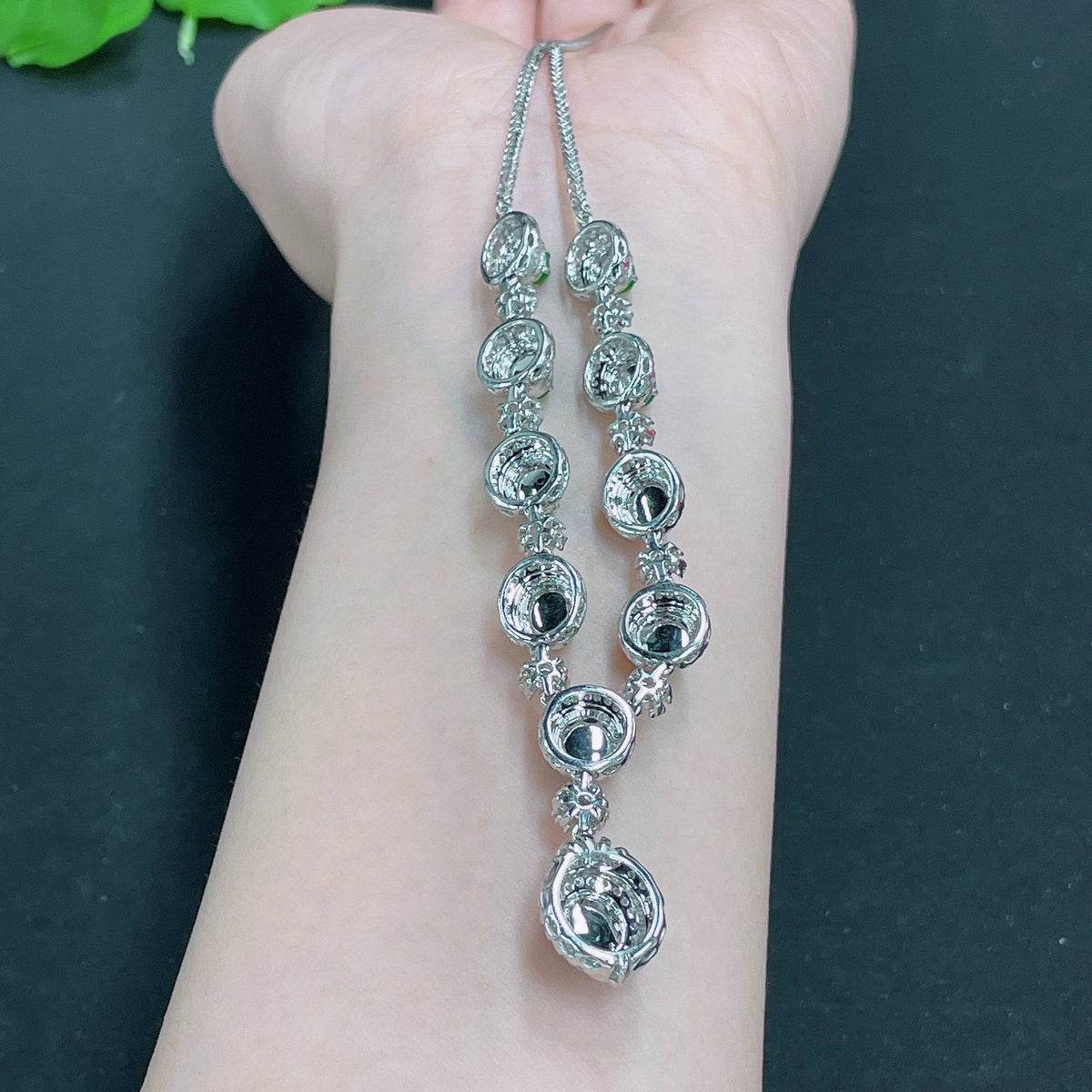 HUILIU HQ jadeite necklace set with sparkling diamonds, featuring a polished jade pendant and matching earrings on a white background.