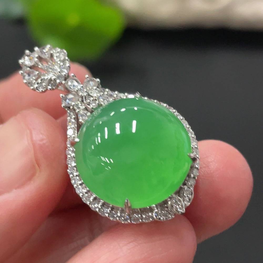 Jadeite cabochon pendant with 18K gold setting and diamond accents, featuring smooth, polished jade gemstone on a delicate chain.