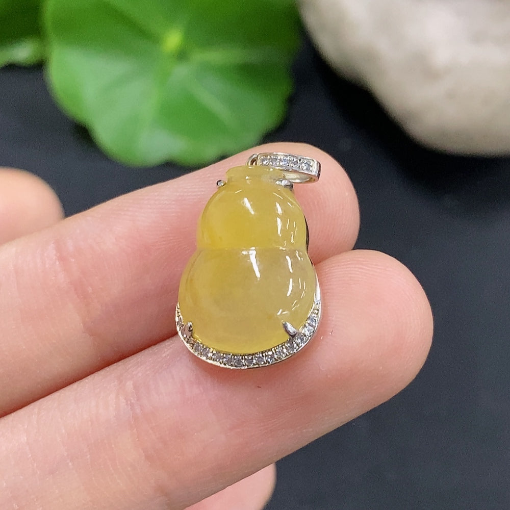 Jadeite gourd pendant with diamond inlays in 18K gold, featuring a small bail and detailed craftsmanship.