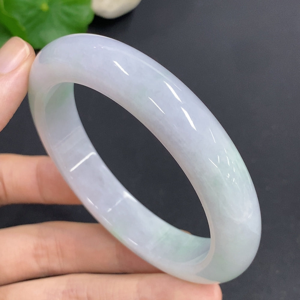 Jadeite round bangle in size 58.7, weighing approximately 68.3g, featuring smooth, polished jade surface with HKHQ branding.