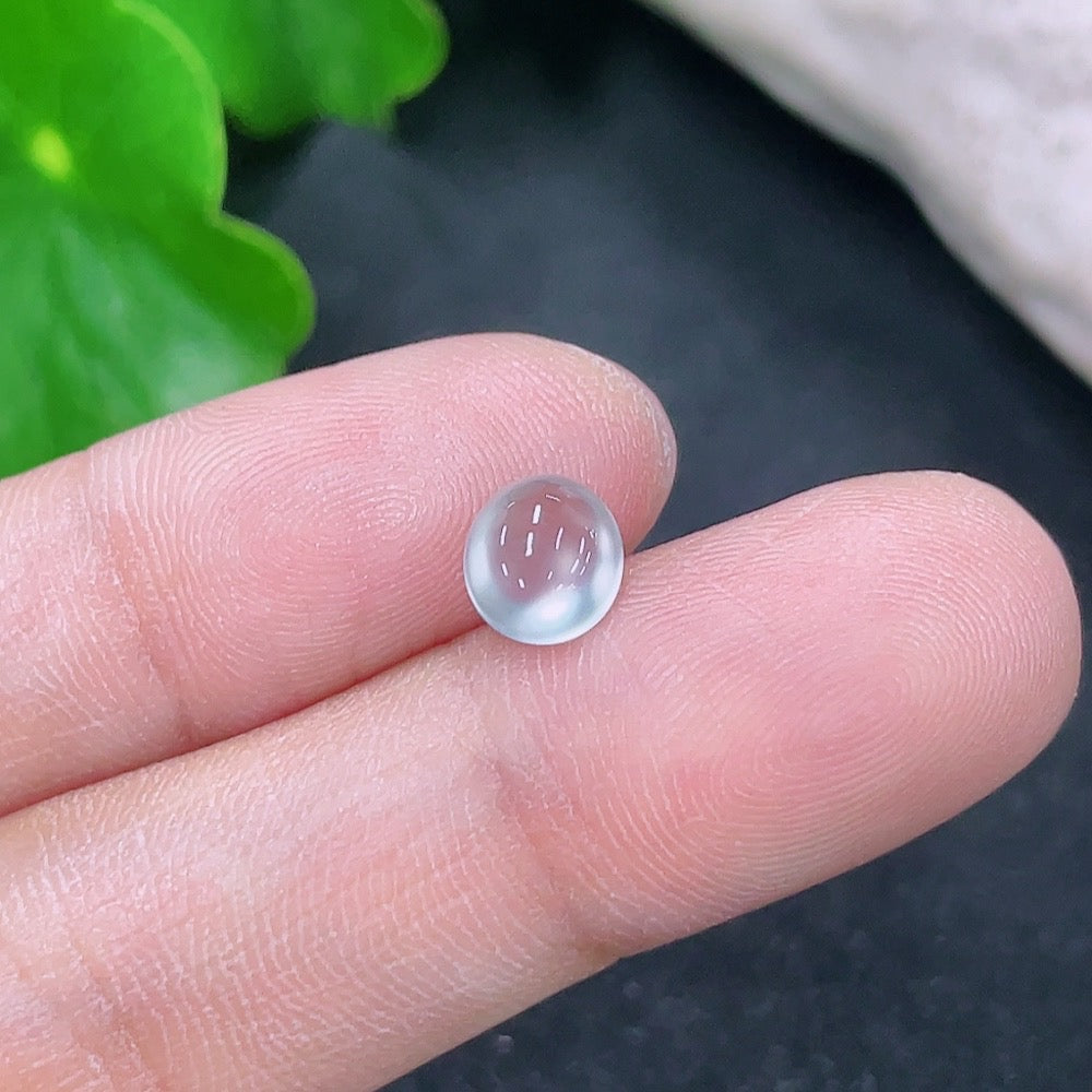 Small jadeite cabochon jewelry piece from HKHQ, showcasing smooth, polished green gemstone with subtle translucence.