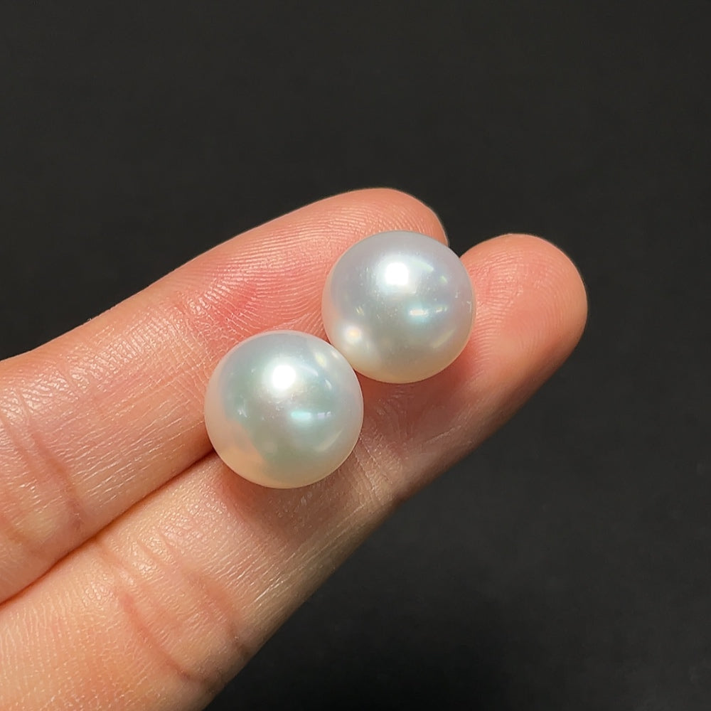 Saltwater pearl earrings with 18K gold setting by HKHQ, featuring lustrous white pearls and delicate gold hooks.