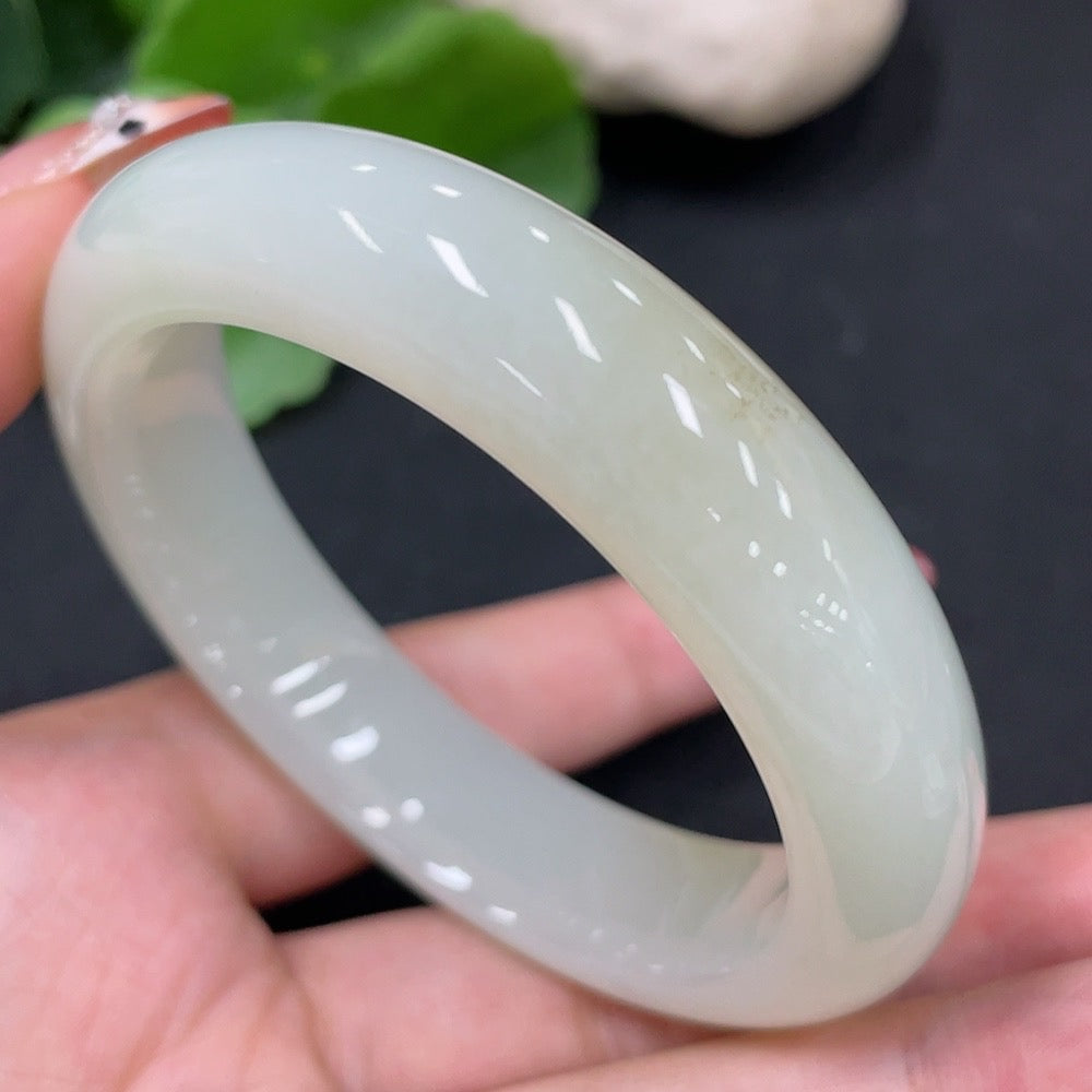 Round Hetian jade bangle by HUILIU HQ, size 55.1, weighing approximately 58.4g, showcasing smooth, polished green jade surface.