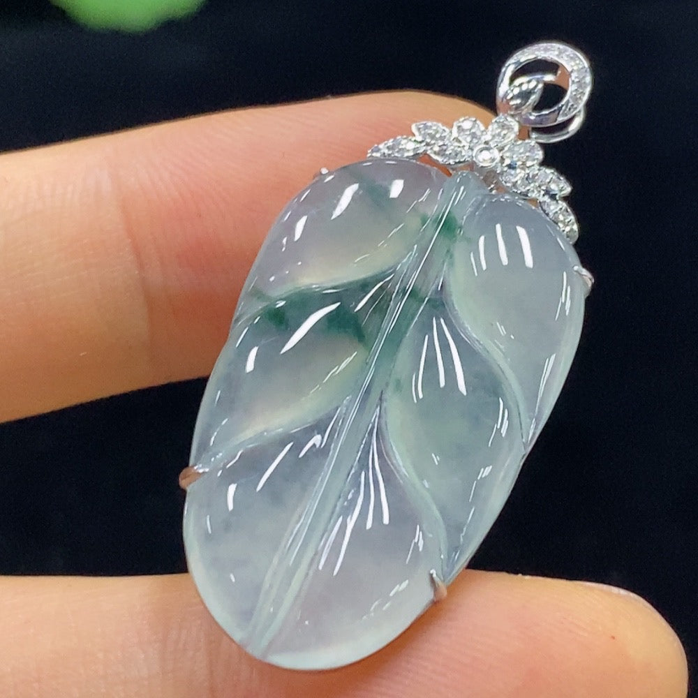 Jadeite leaf pendant by HUILIU HQ featuring 18k gold accents and diamond details, weighing approximately 4.42g.