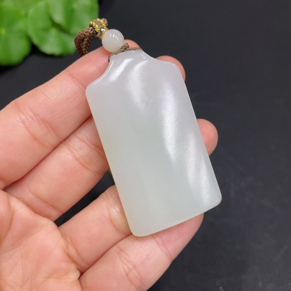 Huiliu certified Hetian jade pendant with a plain, smooth design, showcasing the elegant green jade gemstone.