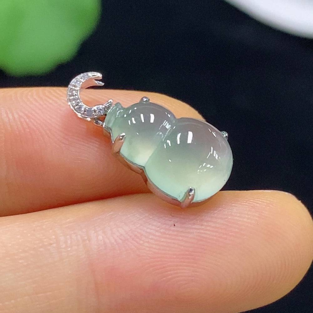 Jadeite gourd pendant with 18k gold inlay and diamond accents, showcasing intricate craftsmanship and elegant design.