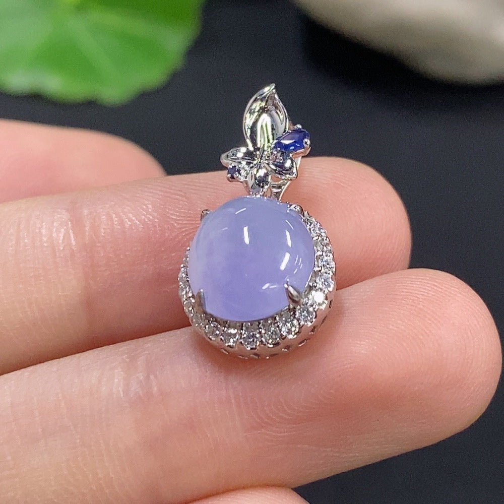 Jadeite cabochon pendant with 18k gold and diamond accents, featuring a polished green jade stone on a delicate gold chain.