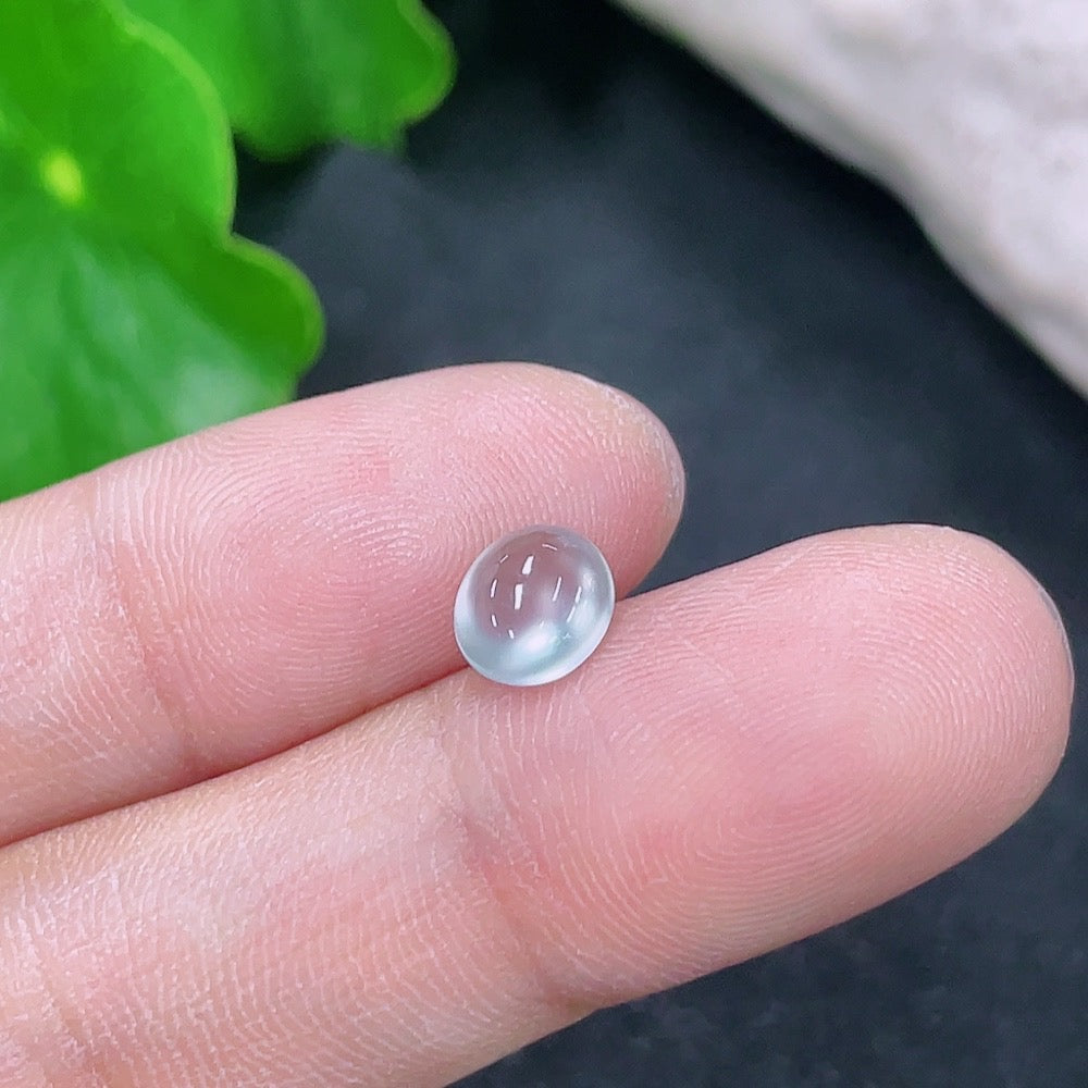 Small jadeite cabochon jewelry piece from HKHQ, showcasing a smooth, polished green gemstone on a neutral background.
