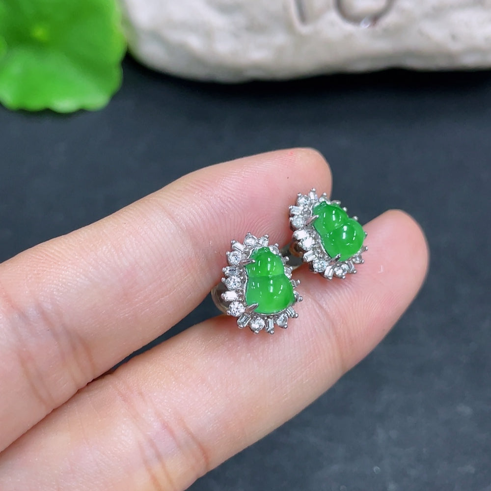 HKHQ jadeite earrings featuring smooth, polished green jade stones with silver-tone hooks, showcasing elegant jewelry design