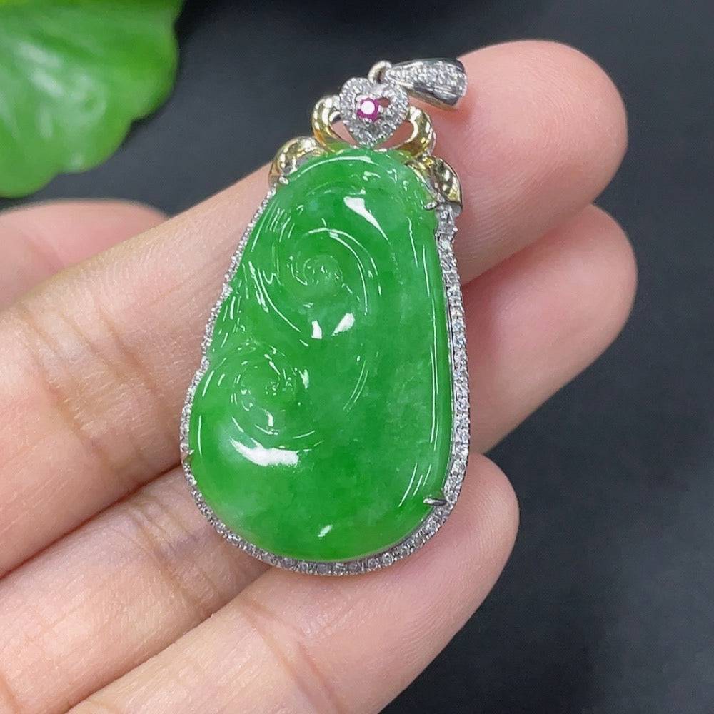 Jadeite inlaid Ruyi pendant with 18k gold and diamonds, showcasing intricate craftsmanship and a smooth, polished surface.