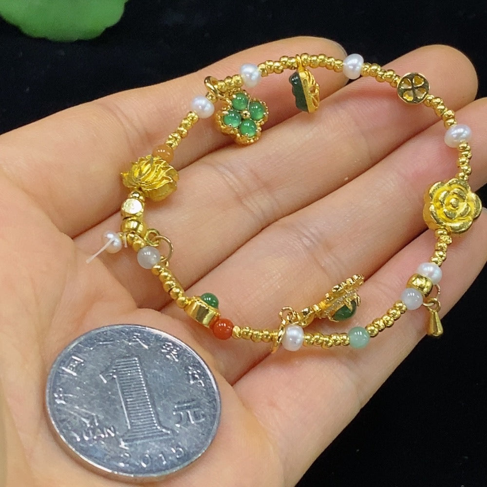 Jadeite inlaid bracelet with small red beads, gold-colored accents, and unmarked surface, featuring fragile jade and non-gold components.