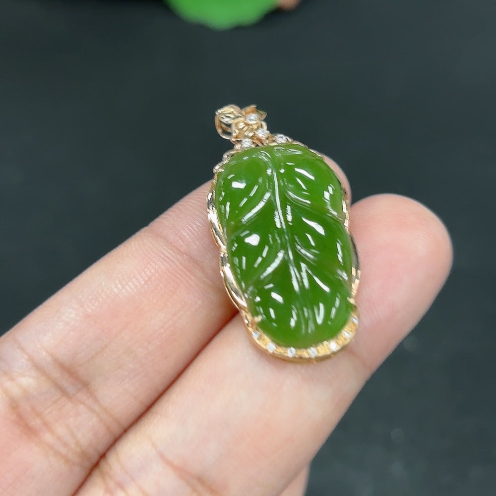 Green Hetian Jade pendant with inlaid design, featuring a "Great Achievements" motif, on a necklace chain from HKHQ.