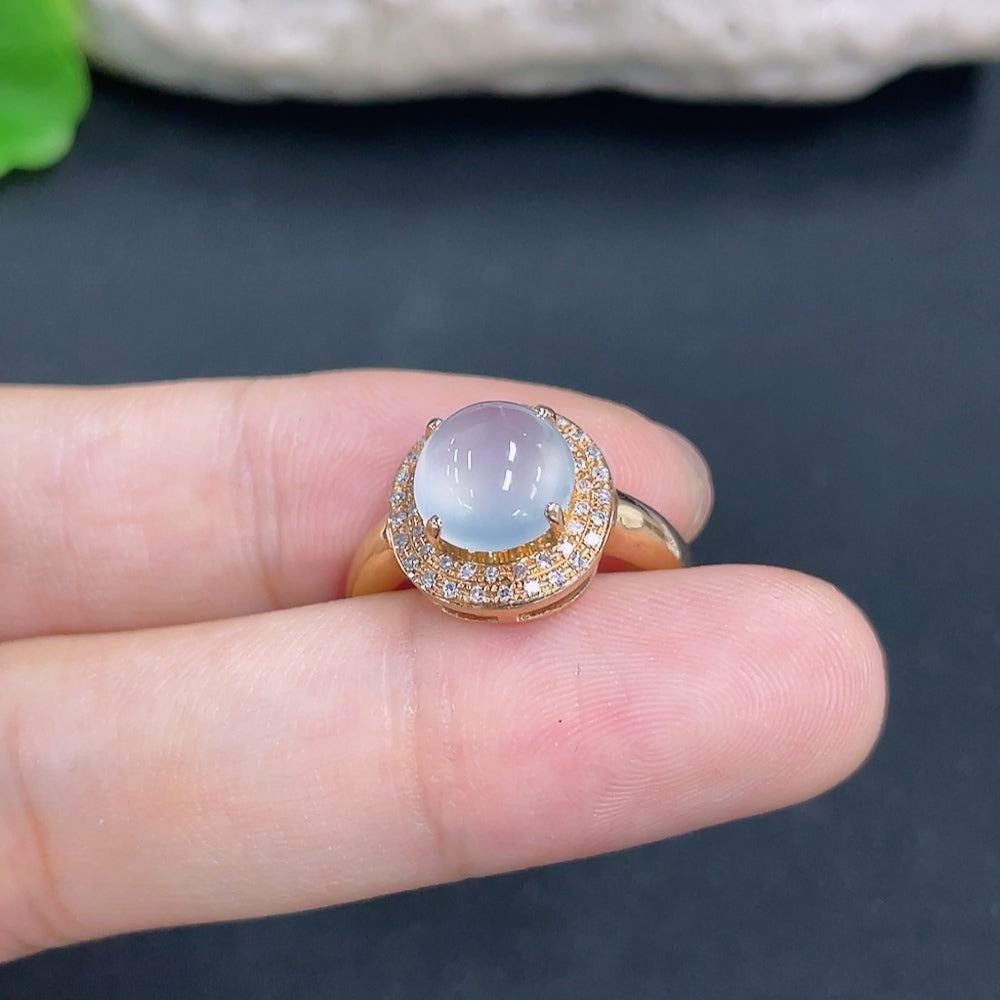 Jadeite ring with 18k gold setting and diamond side stones, size 14, featuring a smooth jade gemstone and intricate design.