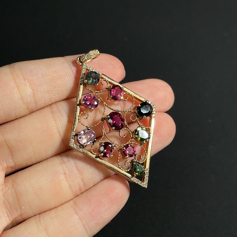 Tourmaline pendant with spinel (light purple, gray blue) and diamond accents, 18k gold