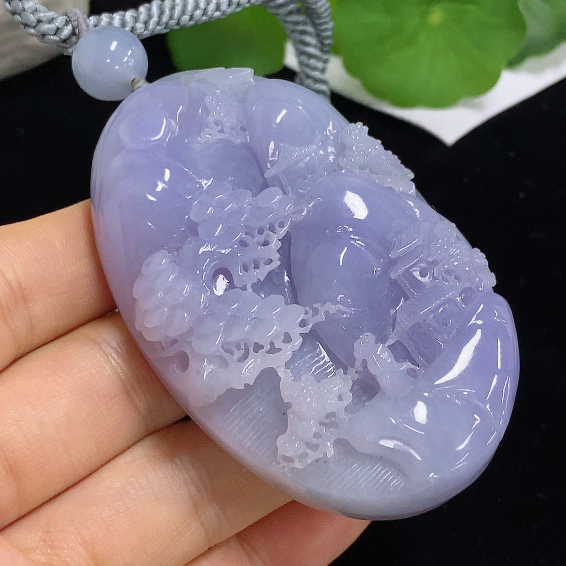 Jadeite pendant with landscape design, HKHQ brand, featuring a rope necklace, weighs approximately 110.3g, showcasing intricate jade craftsmanship.