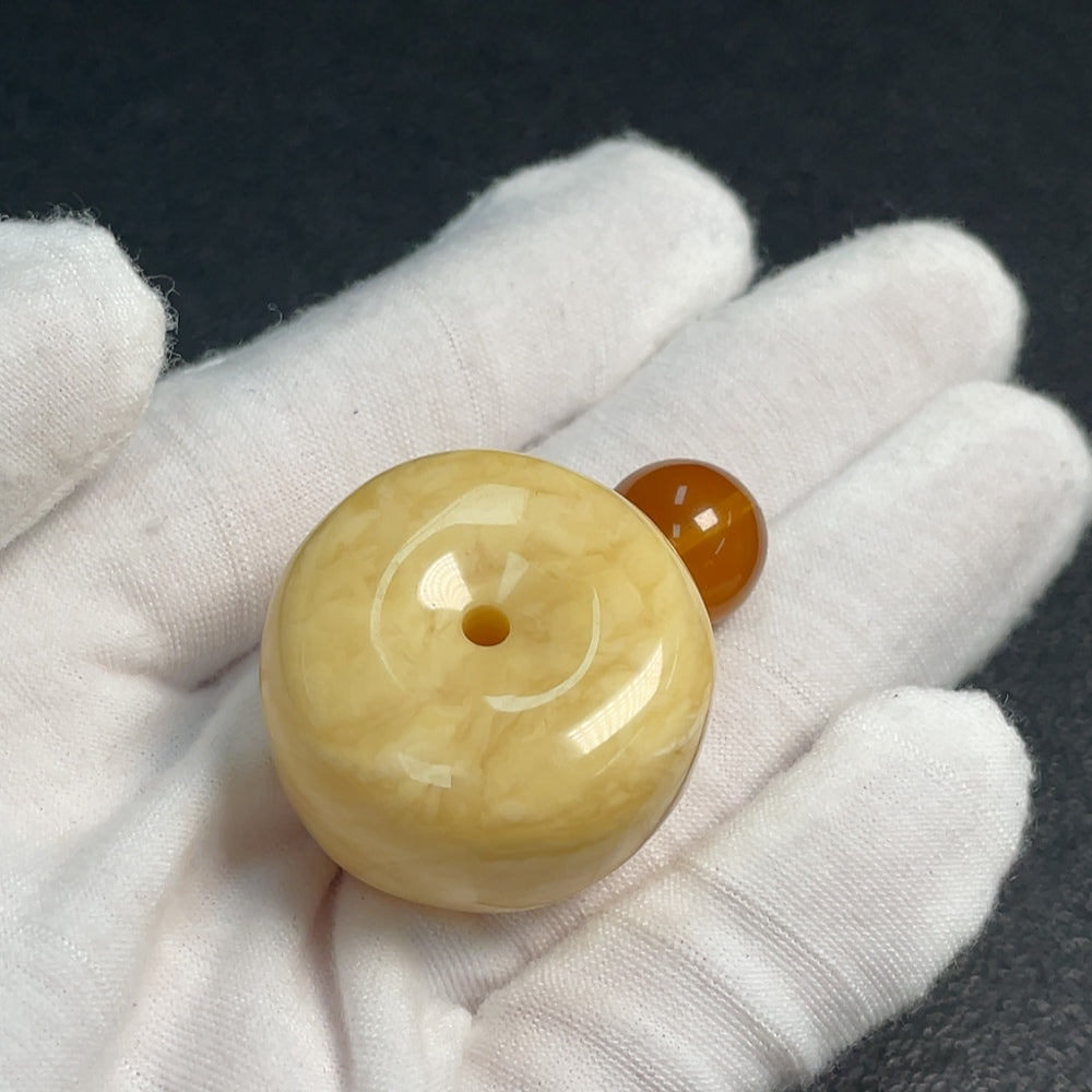 Huiliu certified amber beeswax pendant, natural honey-colored jewelry with polished amber beads on a string.