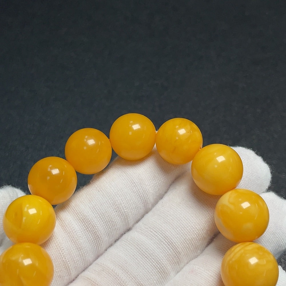 Huiliu Amber Beeswax bracelet with 14.5mm beads, natural amber color, crafted by HUILIU HQ, showcasing the smooth, polished beads.
