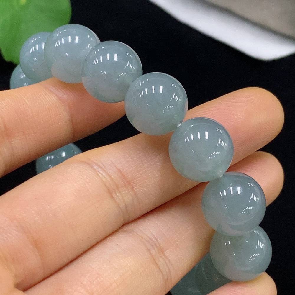 Jadeite bracelet with 13mm beads from HUILIU HQ, showcasing smooth, polished jade stones and a weight of approximately 58 grams.