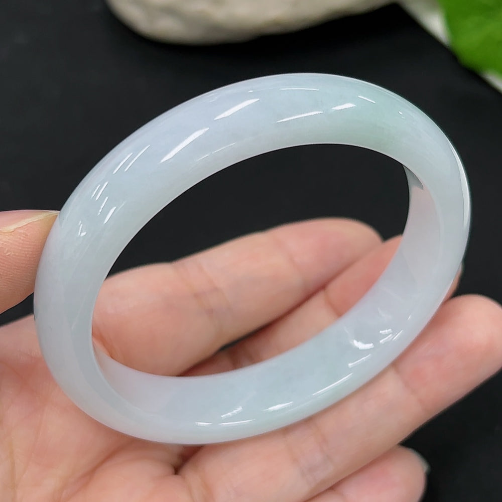 HKHQ jadeite oval bangle in size 54.6 with a weight of 44.9g, showcasing smooth, polished jadeite in a classic oval shape.