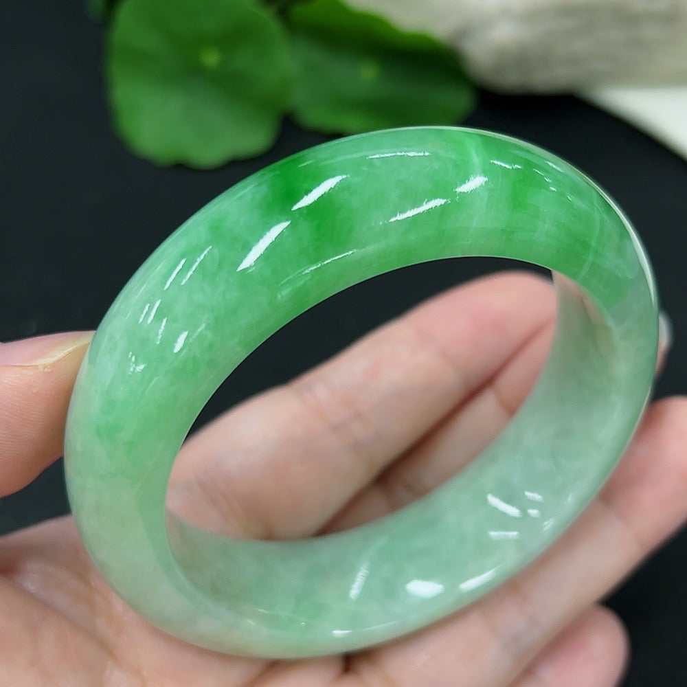 HKHQ jadeite round bangle, size 53.6, with a total weight of 82.02g, showcasing smooth, polished jade in natural light.