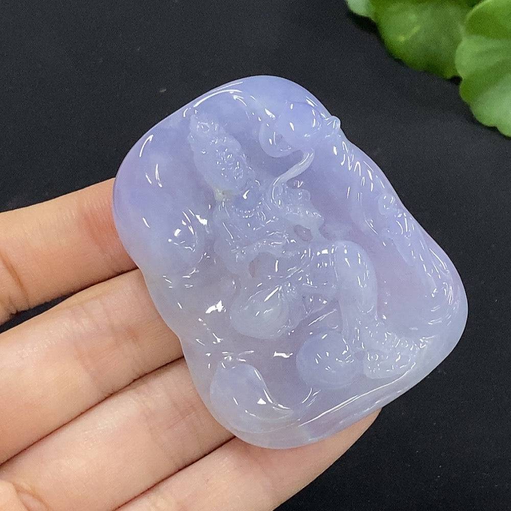 Huiliu Jadeite Guanyin pendant featuring a carved jade figure, certified by Huiliu, displayed against a neutral background.