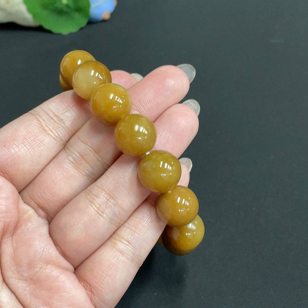 Huiliu HUILIU HQ Hetian Jade bracelet with 13.9mm smooth jade beads, certified by Huiliu, showcasing elegant craftsmanship.
