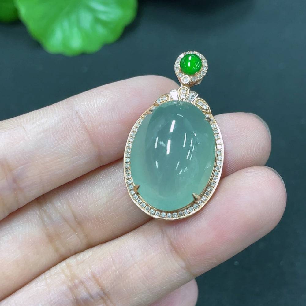 Jadeite cabochon pendant with 18K gold and diamond accents, showcasing a polished jade stone and elegant jewelry design.