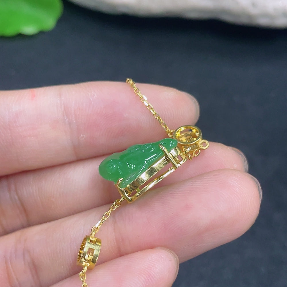Elegant jadeite bracelet with 18K gold and diamond accents, featuring a smooth, polished design and intricate craftsmanship.