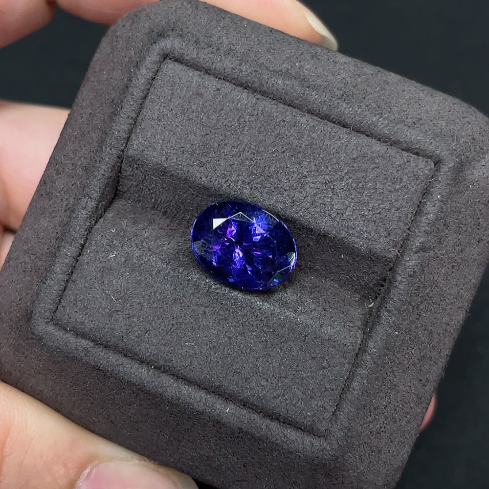 HKHQ tanzanite loose gemstone, approximately 4.82 carats, showcasing vibrant blue-purple color and faceted cut.