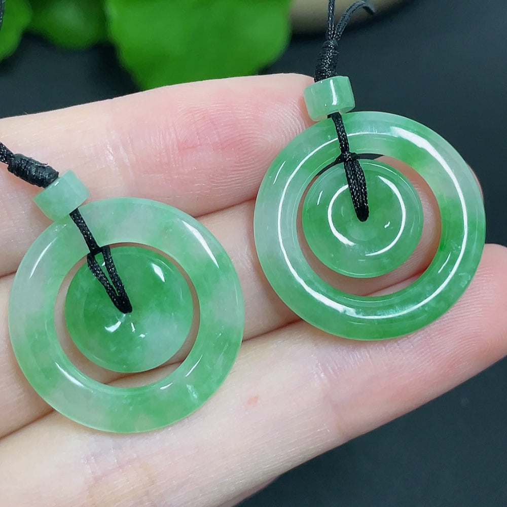 Jadeite pendant featuring mother-and-child buckle design with cord, weighing approximately 6.11g, by HKHQ.