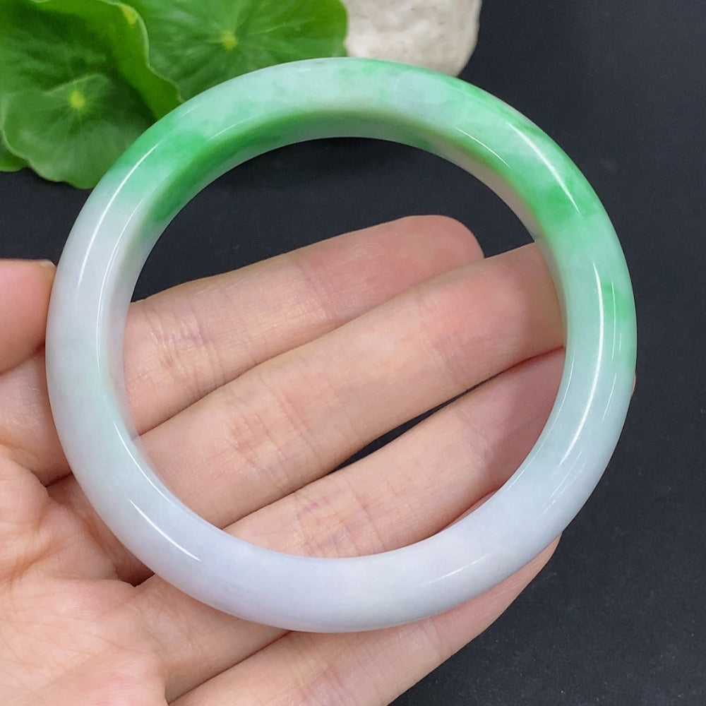 HKHQ jadeite round bangle with a 57.3mm size and 60.6g weight, showcasing smooth polished jadeite surface and circular shape.