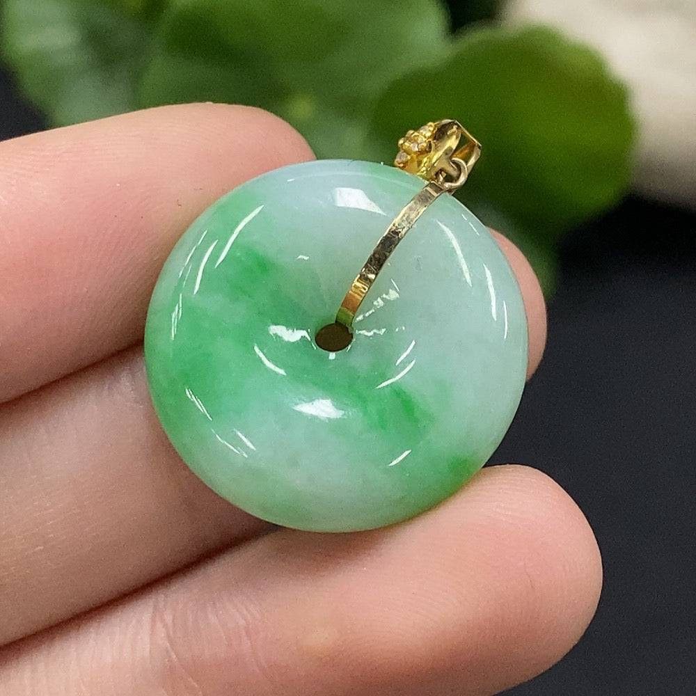 Jadeite safety buckle pendant with 18K gold accents and diamond details, showcasing a polished jade pendant on a chain.