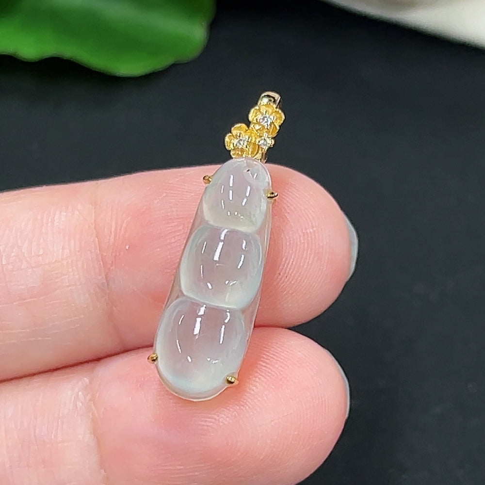 Jadeite auspicious bean pendant in 18K gold with diamond accents, displayed on a necklace chain.