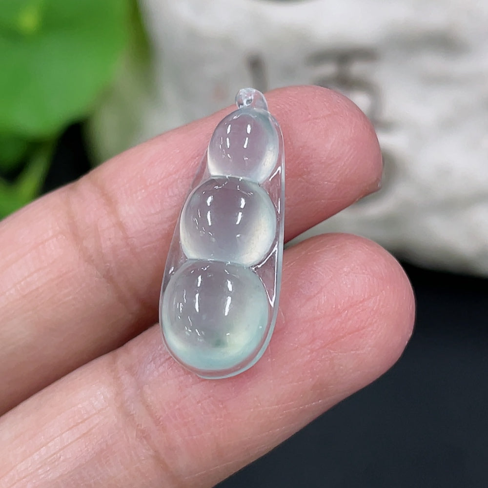 Close-up of HKHQ jadeite auspicious bean inlay piece showing intricate design and smooth green jade surface, weight approximately 1.88g.