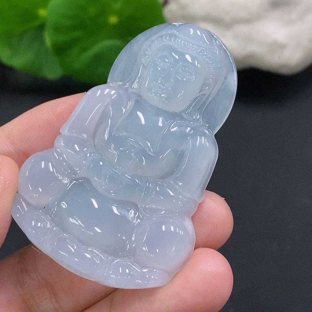 Huiliu Jadeite Guanyin pendant hanging on a cord, showcasing smooth, polished green jade with intricate carved details.