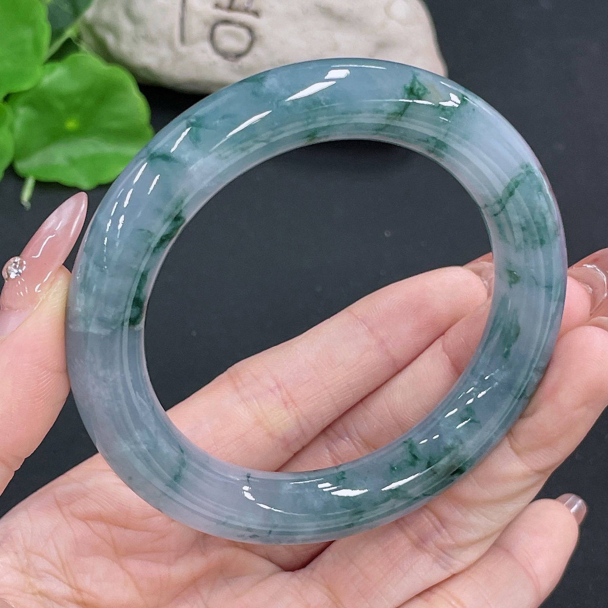 HUILIU HQ jadeite round bangle weighing 74.57g and size 56.3, featuring smooth, polished jade surface with a vibrant green hue.