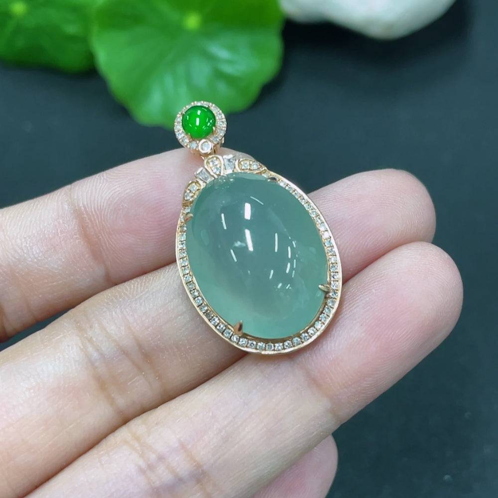Jadeite cabochon pendant with 18K gold setting and diamond accents, featuring a smooth green jade stone, from HUILIU HQ.