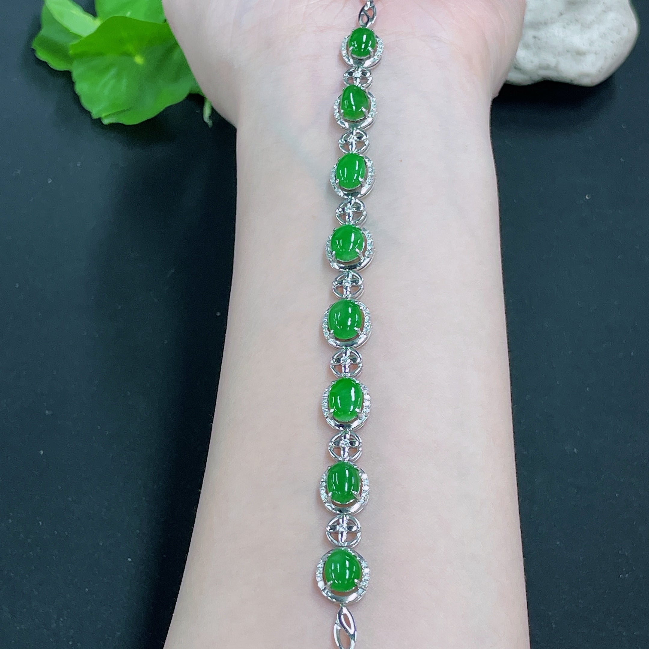 Huiliu jadeite bracelet inlaid with diamonds, featuring polished green jade stones and sparkling diamond accents.