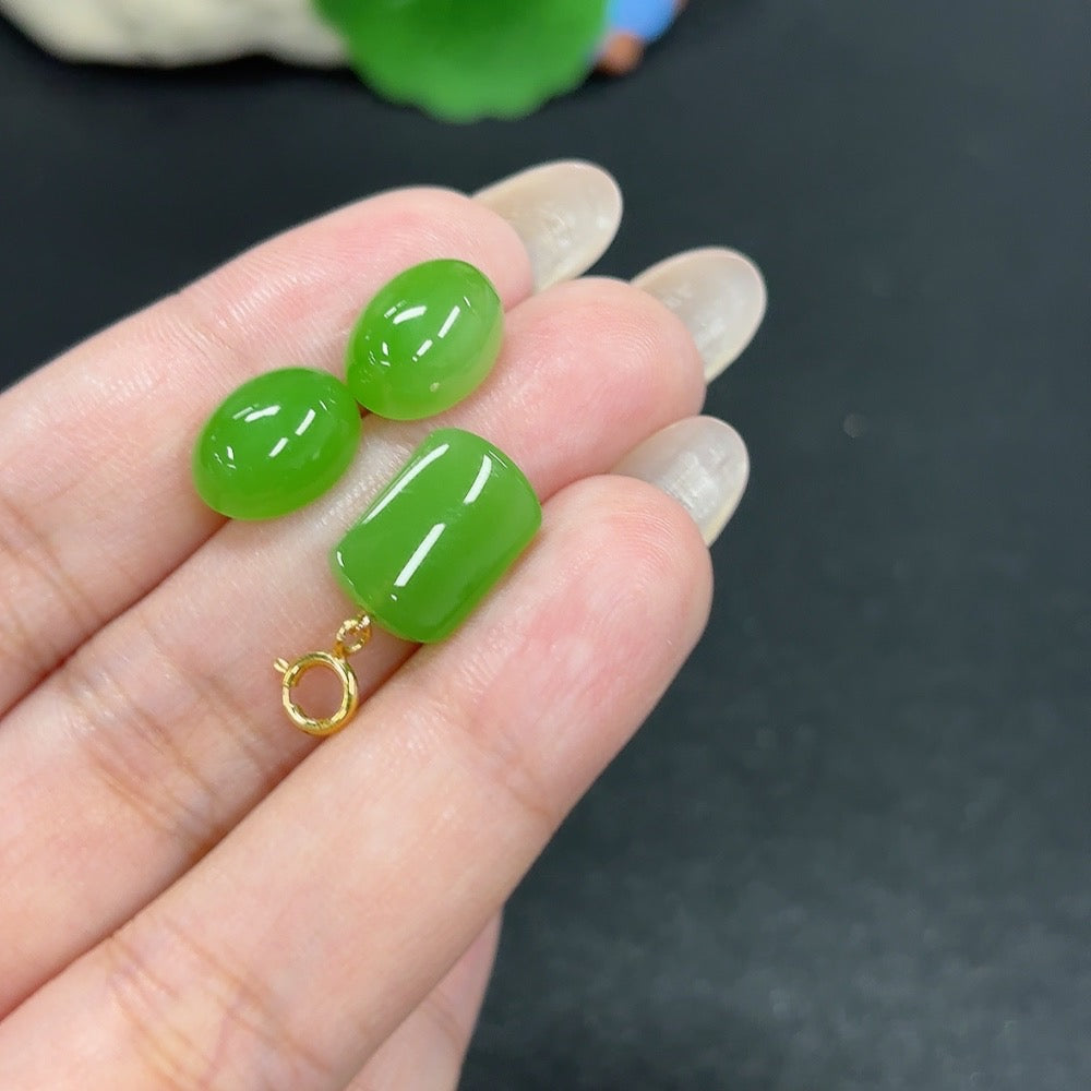 HKHQ Hetian Jade inlaid earrings featuring intricate 18K gold design with matching pendant, showcasing elegant craftsmanship.